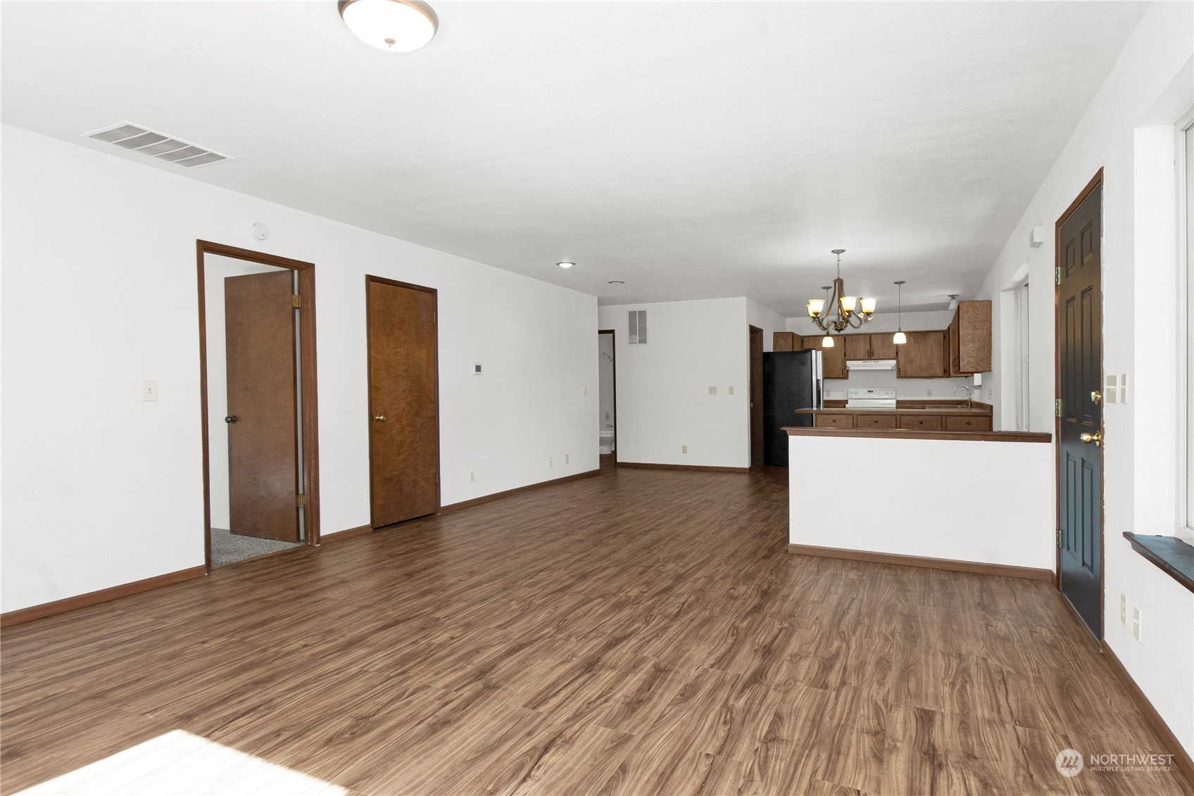 16635 Case Road Southwest Rochester, WA 98579 - Photo 6 of 35 a view of a kitchen with wooden floor and a kitchen