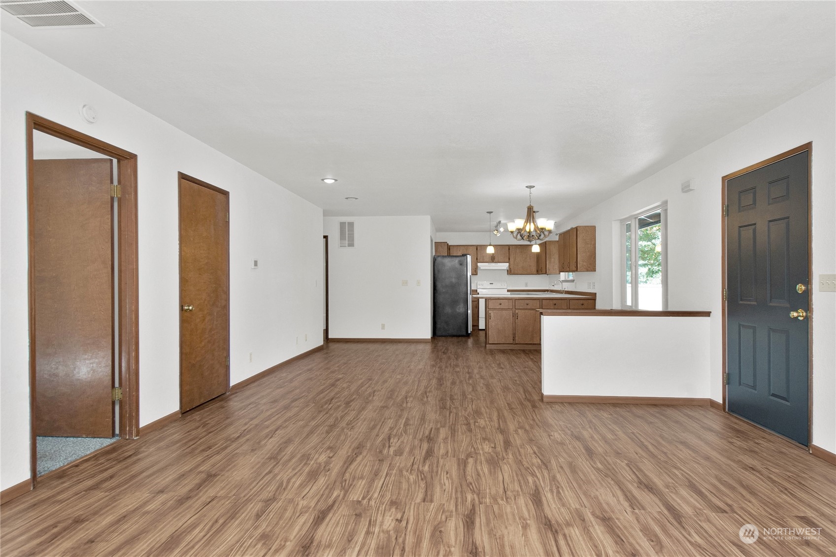 16635 Case Road Southwest Rochester, WA 98579 - Photo 7 of 35 a view of kitchen and kitchen with furniture wooden floor and window