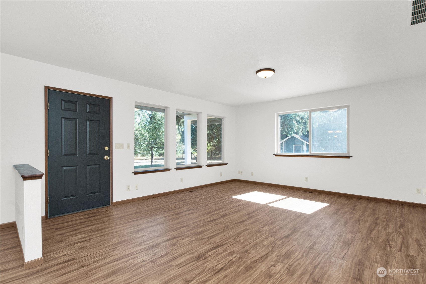 16635 Case Road Southwest Rochester, WA 98579 - Photo 8 of 35 a view of an empty room with wooden floor and a window