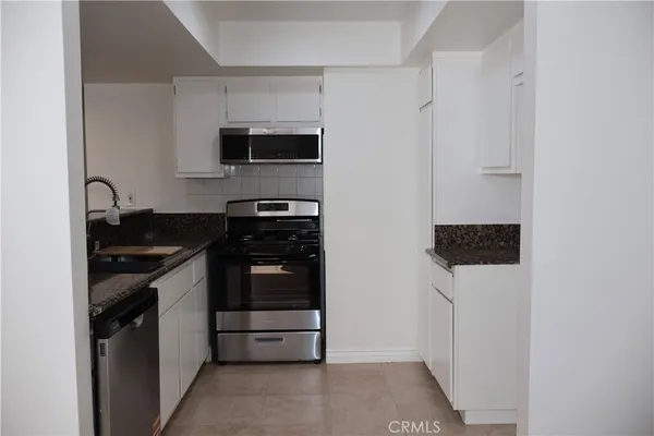 a kitchen with stainless steel appliances a stove and a refrigerator