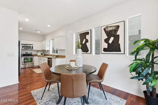 a dining room with furniture and wooden floor