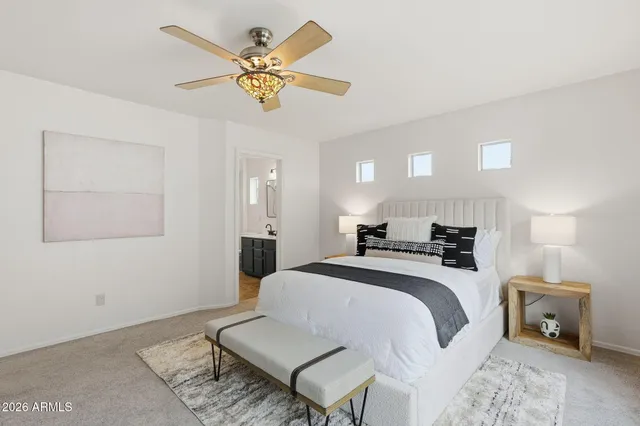 a bedroom with a bed and a chandelier