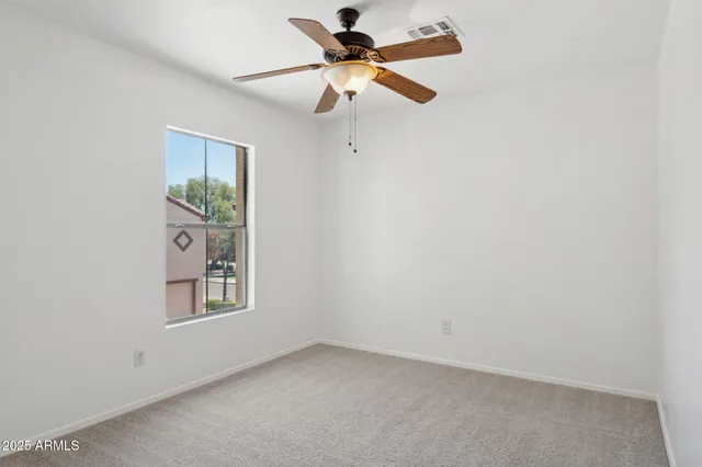 an empty room with a ceiling fan