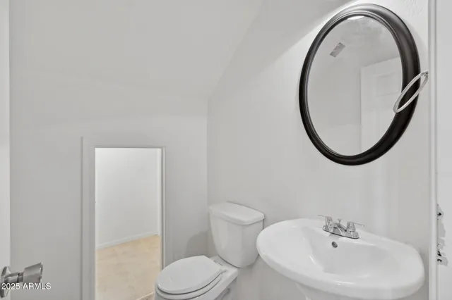 a white toilet sitting next to a bathroom sink