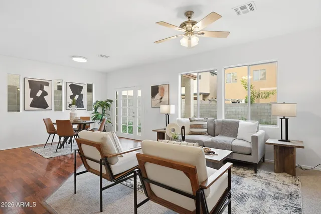 a living room with furniture a table and a large window