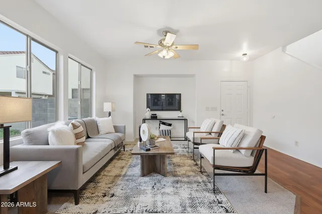 a living room with furniture and a dining table