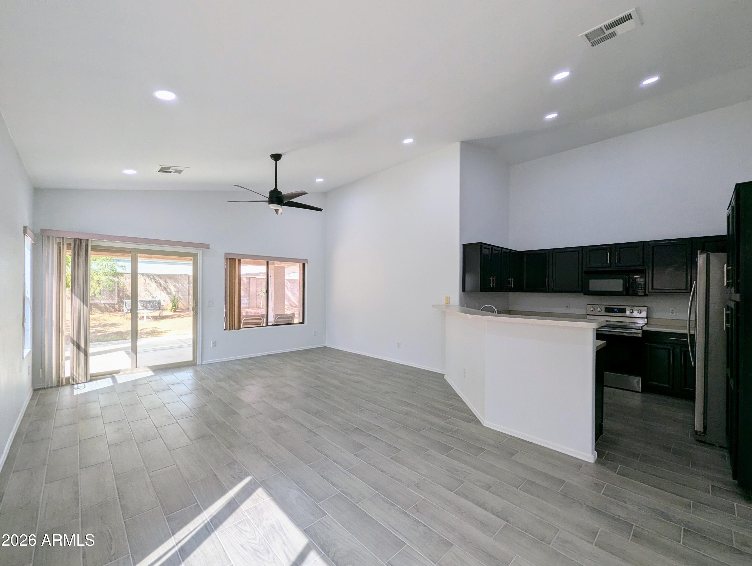 5424 West Wagoner Road Glendale, AZ 85308 - Photo 9 of 37 a kitchen with a refrigerator and a stove top oven