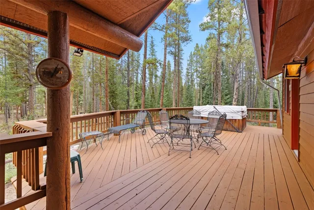a view of a chairs and table on the wooden deck