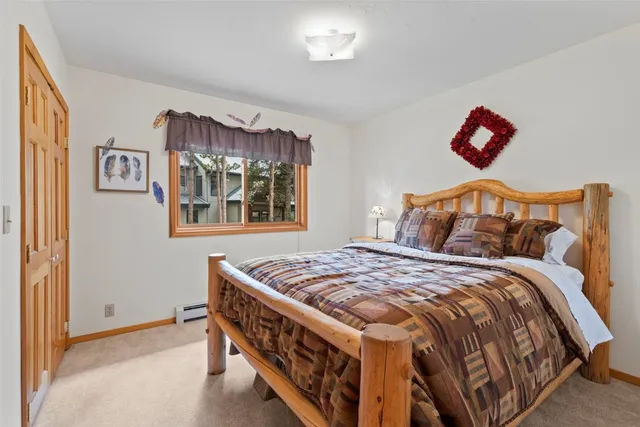 a bedroom with a bed and a painting on the wall