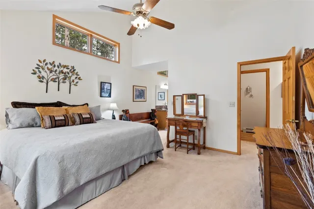 a bedroom with bed table and chair