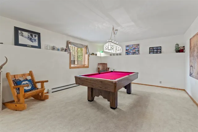 a room with pool table and couch