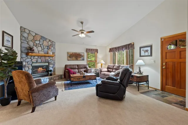 a living room with furniture fireplace and a window