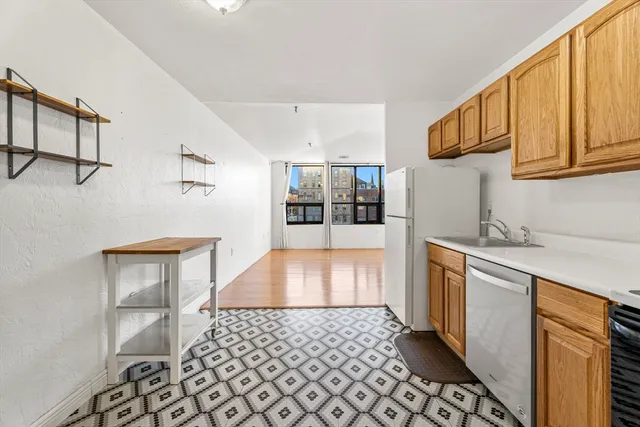 a kitchen with stainless steel appliances a refrigerator and a stove top oven
