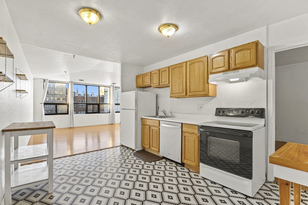 531 Main Street, Unit 403M Worcester, MA 01608 - Photo 15 of 39 a kitchen with stainless steel appliances granite countertop a stove a sink and a refrigerator