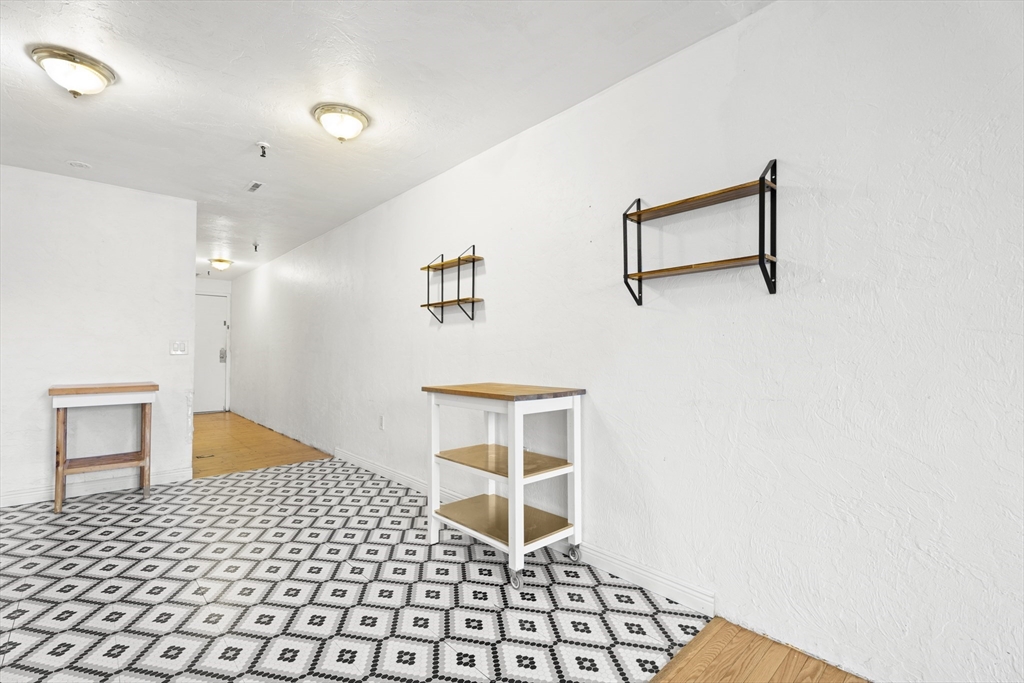 531 Main Street, Unit 403M Worcester, MA 01608 - Photo 18 of 39 a room with a door and a rug