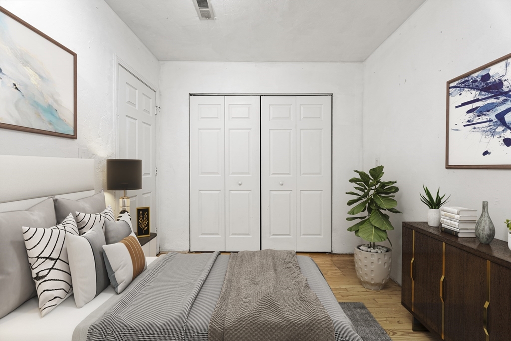 531 Main Street, Unit 403M Worcester, MA 01608 - Photo 19 of 39 a bedroom with a bed and a potted plant