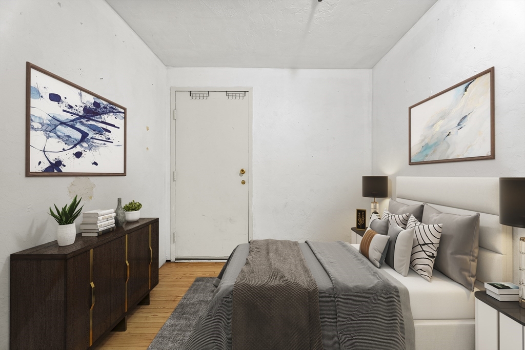 531 Main Street, Unit 403M Worcester, MA 01608 - Photo 21 of 39 a bedroom with a bed and painting on the wall