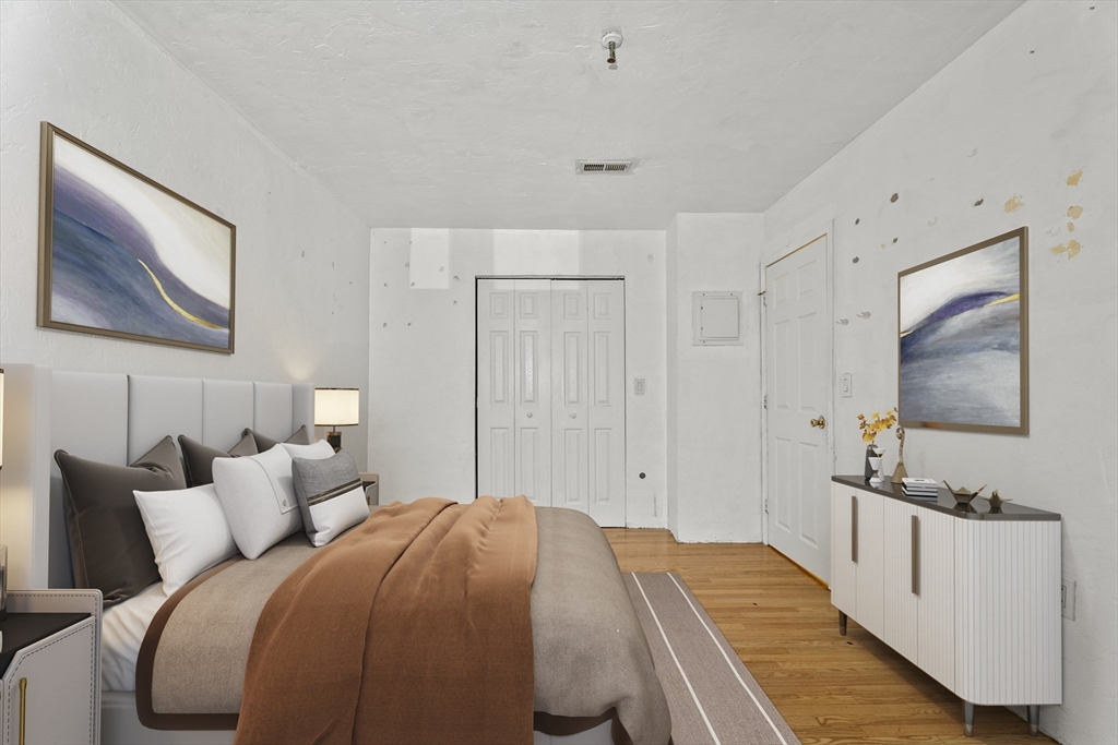 531 Main Street, Unit 403M Worcester, MA 01608 - Photo 26 of 39 a bedroom with a bed and a flat screen tv