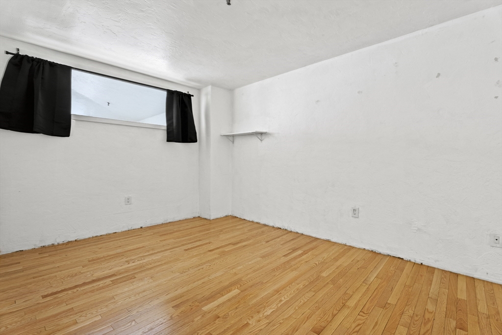 531 Main Street, Unit 403M Worcester, MA 01608 - Photo 28 of 39 a view of empty room with wooden floor and windows