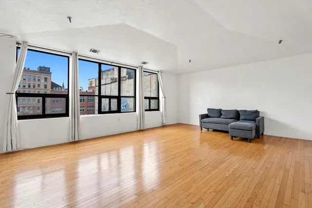 a living room with furniture and a floor to ceiling window