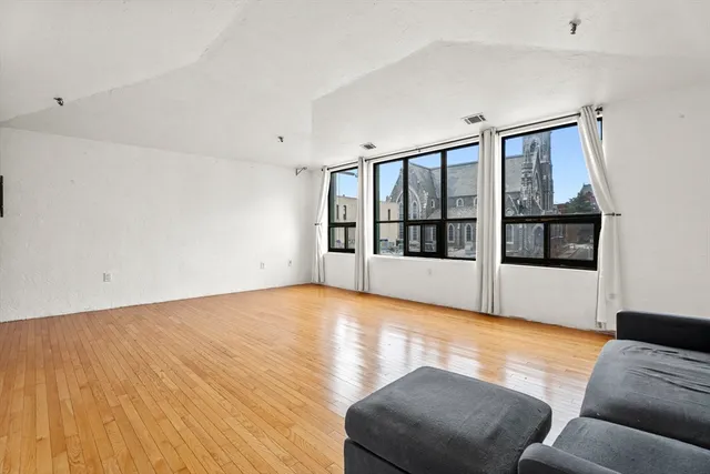 a living room with furniture window and wooden floor