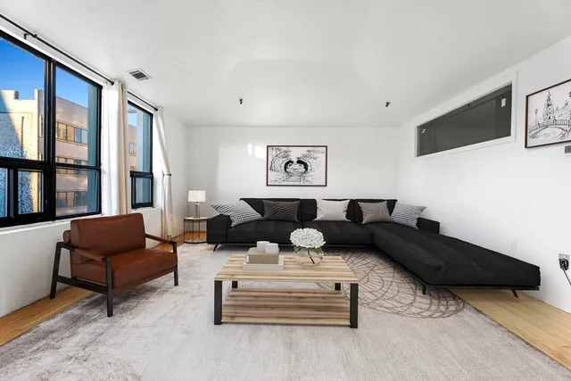 a living room with furniture and a large window