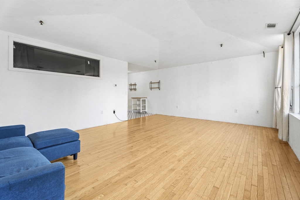 531 Main Street, Unit 403M Worcester, MA 01608 - Photo 9 of 39 a bedroom with a bed and a flat screen tv