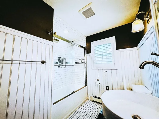 a bathroom with a sink and mirror