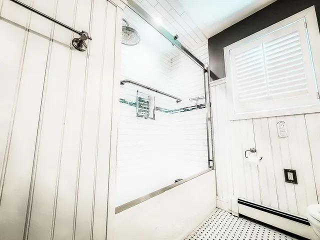 a bathroom with a shower and a shower