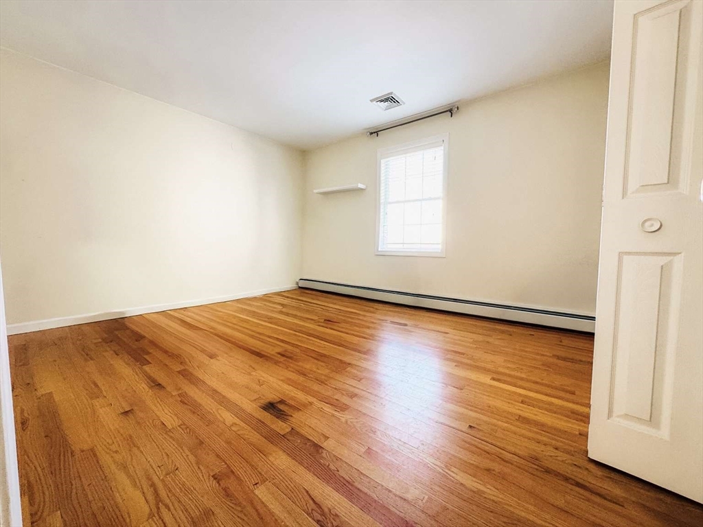 70 Brown Street Fall River, MA 02724 - Photo 19 of 31 an empty room with wooden floor and windows