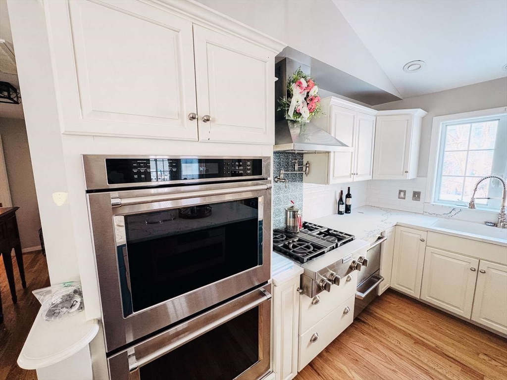 70 Brown Street Fall River, MA 02724 - Photo 22 of 31 a kitchen with cabinets a stove and a sink