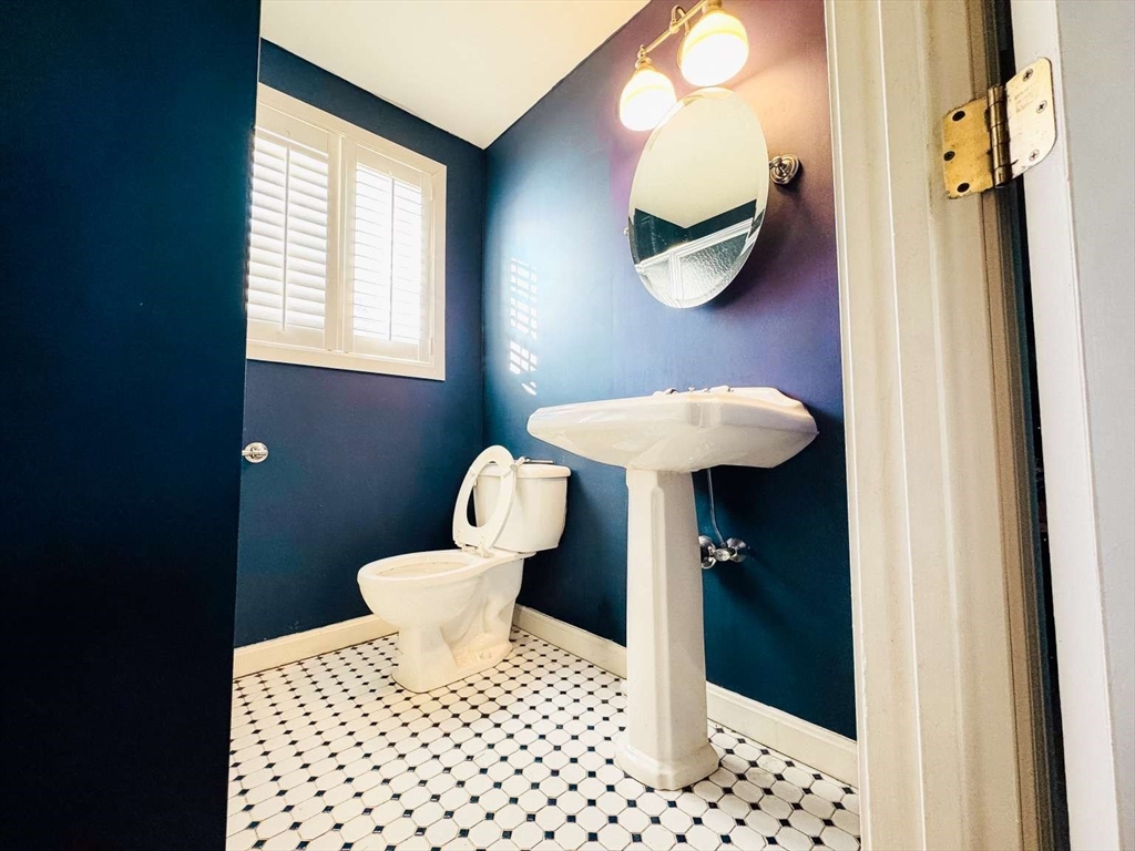 70 Brown Street Fall River, MA 02724 - Photo 28 of 31 a bathroom with a sink a toilet and mirror