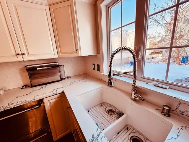 a kitchen with a sink a counter top space and a window