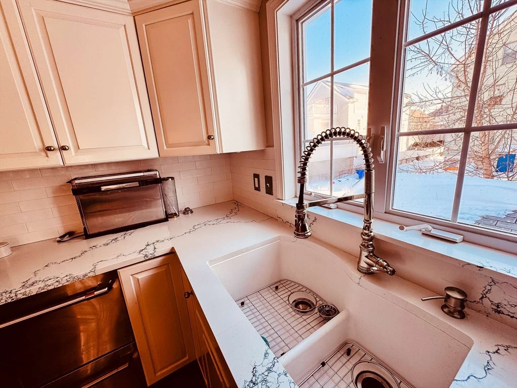 70 Brown Street Fall River, MA 02724 - Photo 7 of 31 a kitchen with a sink a counter top space and a window