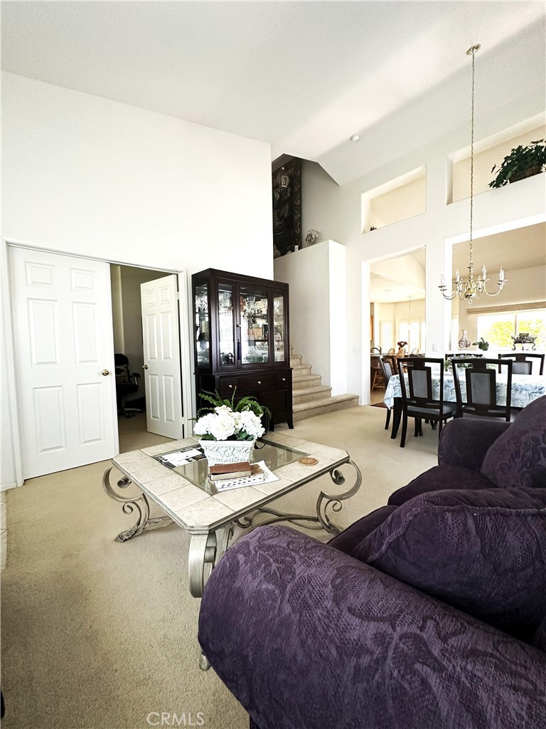 1665 Ravenswood Road Beaumont, CA 92223 - Photo 5 of 41 a living room with furniture and a table
