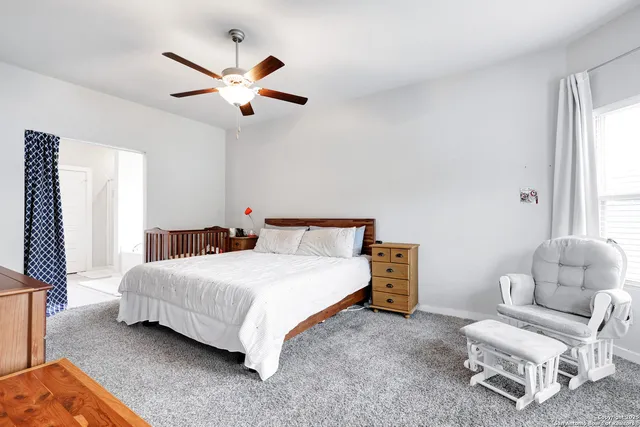 a bedroom with a bed furniture and a window