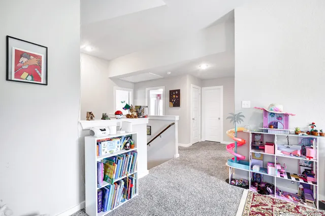 a living room with lots of furniture and baby crib