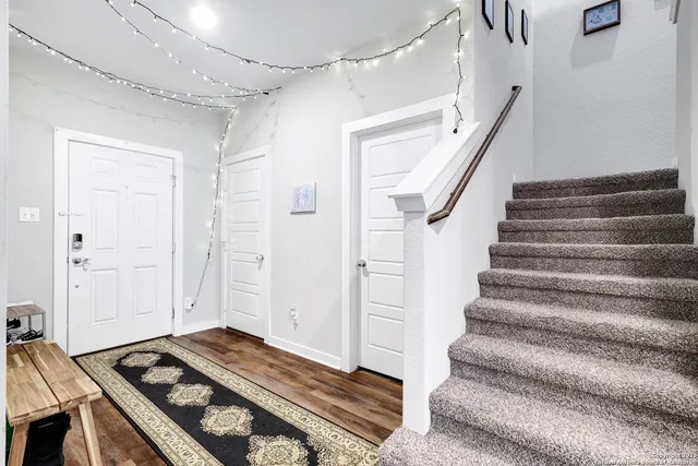 a view of a livingroom with white walls and stairs