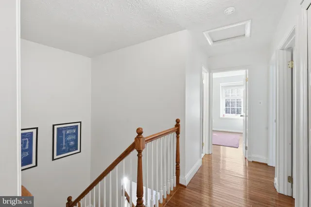 a bedroom with a bed wooden floor and window
