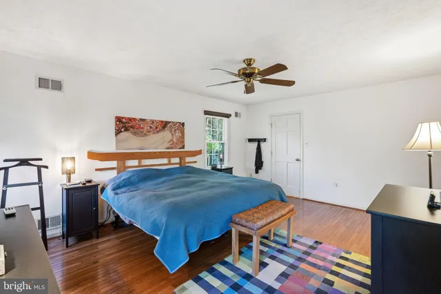 a spacious bathroom with a double vanity sink a large mirror and shower