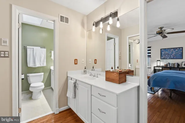 a bathroom with a toilet sink and mirror