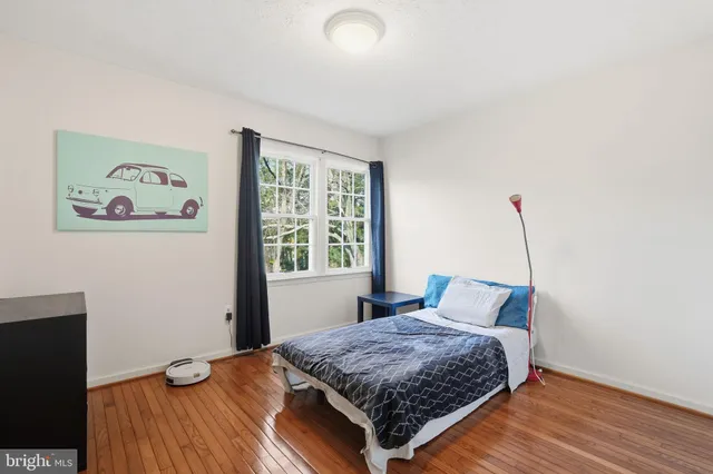 a living room with furniture and a book shelf