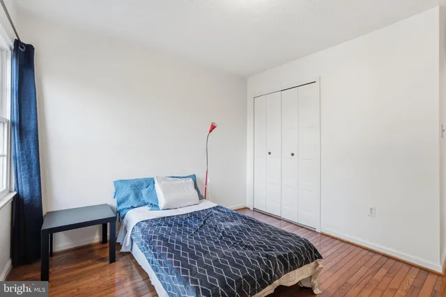 a bedroom with bed and a window