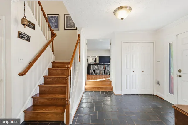 a view of entryway and hall with wooden floor