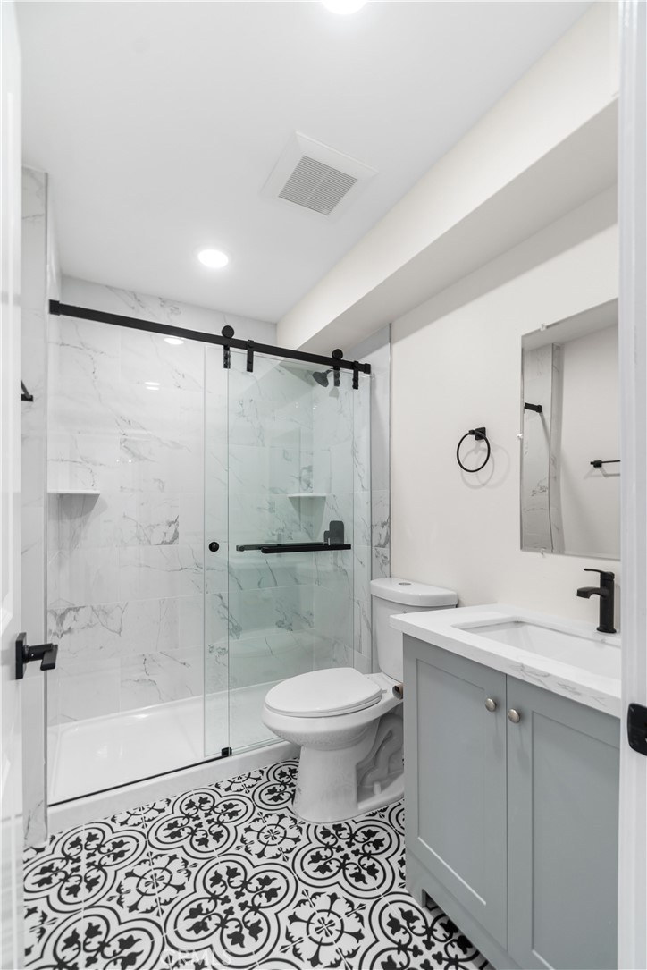 523 West 12th Street, Unit 5 San Pedro, CA 90731 - Photo 12 of 14 a bathroom with a sink toilet and shower