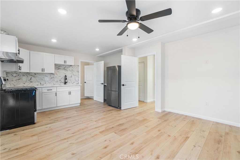 523 West 12th Street, Unit 5 San Pedro, CA 90731 - Photo 3 of 14 a large kitchen with stainless steel appliances a refrigerator and a stove top oven