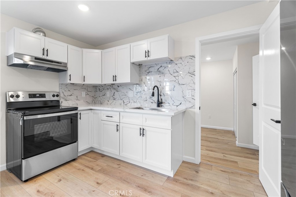 523 West 12th Street, Unit 5 San Pedro, CA 90731 - Photo 5 of 14 a kitchen with stainless steel appliances a stove a sink and a microwave