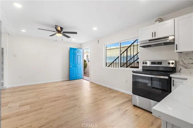 a kitchen with stainless steel appliances a stove and a refrigerator