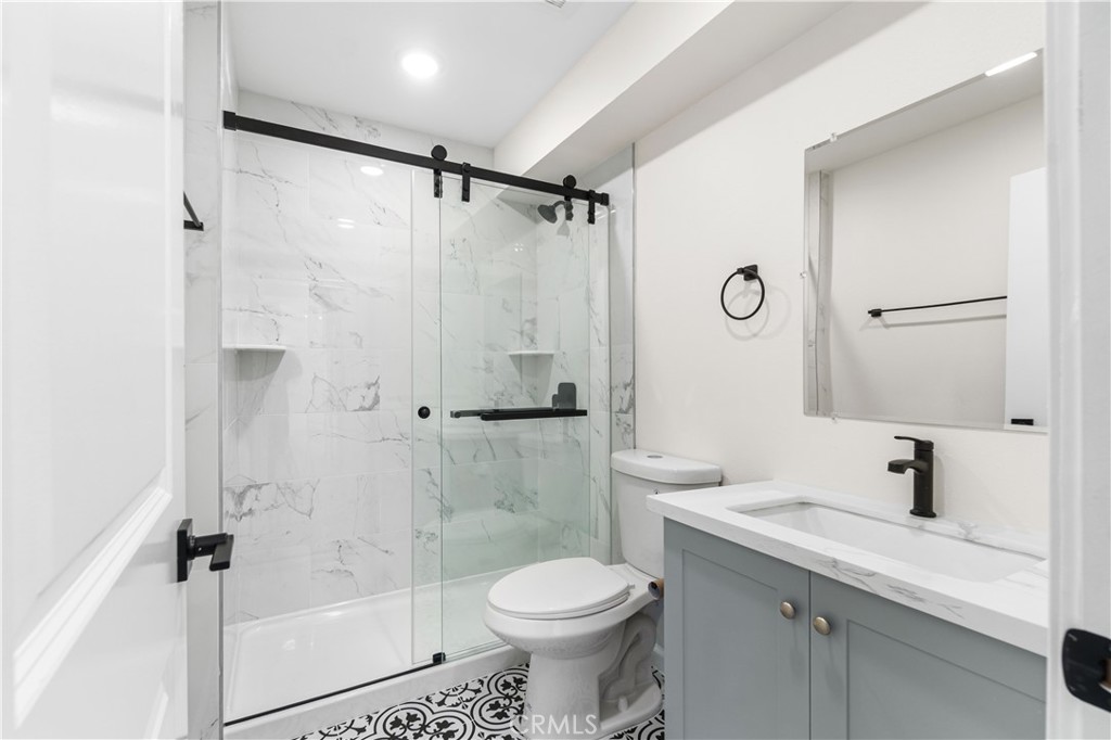 523 West 12th Street, Unit 5 San Pedro, CA 90731 - Photo 10 of 14 a bathroom with a sink toilet and shower