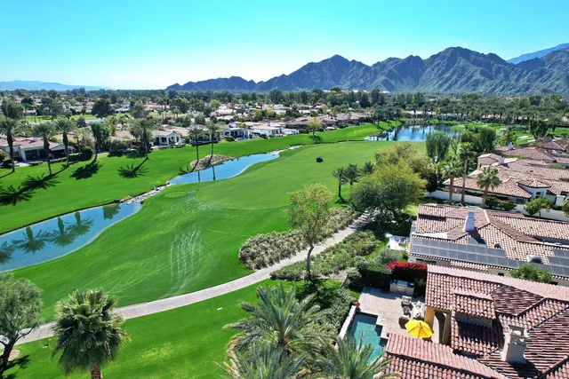 a view of a lush green hillside and houses